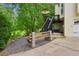 Home's backyard with wood stairs leading to a deck, hot tub, and natural surroundings at 1667 Willow Way, Woodstock, GA 30188