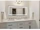 Bright bathroom features a double vanity with a white countertop and a large, illuminated mirror at 1667 Willow Way, Woodstock, GA 30188