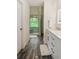 Bathroom with dual sink vanity, decorative shower with art glass and wood look flooring at 1667 Willow Way, Woodstock, GA 30188