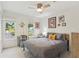 Well-lit bedroom featuring a ceiling fan, two windows and decoratively adorned walls at 1667 Willow Way, Woodstock, GA 30188