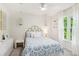 Cozy bedroom featuring bright natural light, a blue and white bedspread, and unique hanging lamps at 1667 Willow Way, Woodstock, GA 30188