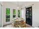 Bright breakfast nook with three windows, sliding barn door and stacked washer/dryer at 1667 Willow Way, Woodstock, GA 30188