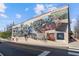 Large, colorful mural depicting local history on the side of a building at 1667 Willow Way, Woodstock, GA 30188