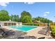 Community pool with lounge chairs and tables offering a relaxing atmosphere under a bright blue sky at 1667 Willow Way, Woodstock, GA 30188