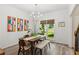 Bright dining room showcasing modern decor, a stylish chandelier, and large window views at 1667 Willow Way, Woodstock, GA 30188