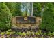Stone sign with the 'Willow Tree' logo, surrounded by manicured landscaping and lush greenery at 1667 Willow Way, Woodstock, GA 30188