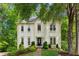 Charming two-story home with manicured lawn and lush, mature trees enhancing curb appeal at 1667 Willow Way, Woodstock, GA 30188