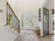 Inviting foyer with a staircase featuring wood and wrought iron, and modern decor at 1667 Willow Way, Woodstock, GA 30188