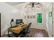 Bright home office with wood floors, ample desk space, ceiling fan, and a pleasant window view at 1667 Willow Way, Woodstock, GA 30188