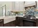 Stylish kitchen features a decorative farmhouse sink, modern appliances and eye-catching backsplash at 1667 Willow Way, Woodstock, GA 30188