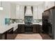 Modern kitchen with stainless steel appliances, custom cabinets, a stylish backsplash, and plenty of counter space at 1667 Willow Way, Woodstock, GA 30188