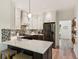 Well-designed kitchen featuring stainless steel appliances, custom cabinets, and a marble countertop with barstool seating at 1667 Willow Way, Woodstock, GA 30188