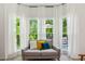 Cozy sitting area with large windows offering peaceful views, complete with comfortable seating and natural light at 1667 Willow Way, Woodstock, GA 30188