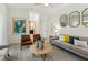 Inviting living room with hardwood floors, modern furnishings and access to the kitchen at 1667 Willow Way, Woodstock, GA 30188