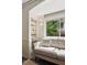 Cozy sitting room featuring a plush sofa, built-in shelving, and natural light at 1667 Willow Way, Woodstock, GA 30188
