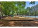 Community playground featuring slides and swings, bordered by mulch and pine straw for safety at 1667 Willow Way, Woodstock, GA 30188