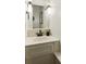 Compact powder room features a sleek vanity with modern fixtures and ample lighting at 1667 Willow Way, Woodstock, GA 30188