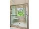 Modern shower showcasing a unique stained glass window and built in seating at 1667 Willow Way, Woodstock, GA 30188
