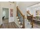 Carpeted staircase with a wrought iron railing leading to the upper level, blending style and safety at 1667 Willow Way, Woodstock, GA 30188