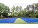 Outdoor tennis courts for community enjoyment surrounded by lush trees in this wonderful neighborhood at 1667 Willow Way, Woodstock, GA 30188