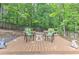 Outdoor living space features a cozy wooden deck, floral chairs, and surrounding wooded views at 4546 Windsor Oaks Ct, Marietta, GA 30066