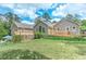 Landscaped backyard with large grassy area, wood deck, and built-in ramp for easy access to the home at 4546 Windsor Oaks Ct, Marietta, GA 30066
