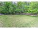 Well-maintained expansive backyard with green grass and perimeter fencing for privacy at 4546 Windsor Oaks Ct, Marietta, GA 30066