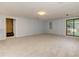 Finished basement with neutral carpet, access to the backyard through a sliding glass door, and staircase at 4546 Windsor Oaks Ct, Marietta, GA 30066