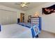 Cozy bedroom featuring a ceiling fan, carpeted floors and a blue and white quilt on the bed at 4546 Windsor Oaks Ct, Marietta, GA 30066