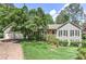 Charming home featuring a manicured lawn, mature trees, and a spacious two-car garage at 4546 Windsor Oaks Ct, Marietta, GA 30066