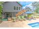 Backyard pool area with lounge seating and access to the house from an elevated back deck and patio at 4546 Windsor Oaks Ct, Marietta, GA 30066