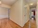 Hallway with hardwood floors and neutral paint, connecting various rooms at 4546 Windsor Oaks Ct, Marietta, GA 30066