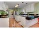 Modern kitchen features stainless steel appliances, white cabinets, and hardwood floors at 4546 Windsor Oaks Ct, Marietta, GA 30066