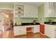 Kitchen area with a built-in desk, white cabinets, and hardwood floors at 4546 Windsor Oaks Ct, Marietta, GA 30066