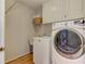 Functional laundry room featuring a washer, dryer, and storage cabinets at 4546 Windsor Oaks Ct, Marietta, GA 30066
