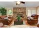 Bright living room with brick fireplace, hardwood floors, and large windows at 4546 Windsor Oaks Ct, Marietta, GA 30066