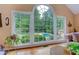 Living room with large windows offering a view of the pool and greenery at 4546 Windsor Oaks Ct, Marietta, GA 30066
