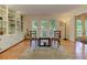 Sunlit living room boasts hardwood floors, built-in shelving, and large windows at 4546 Windsor Oaks Ct, Marietta, GA 30066