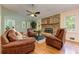 Cozy living room with brick fireplace, hardwood floors, and comfortable leather seating at 4546 Windsor Oaks Ct, Marietta, GA 30066