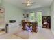 Home office features a traditional desk, built-in bookcases, and abundant natural light from large windows at 4546 Windsor Oaks Ct, Marietta, GA 30066