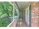 Covered porch featuring classic columns, brick detailing, and a serene outdoor space at 4546 Windsor Oaks Ct, Marietta, GA 30066