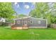 Backyard with spacious, well-manicured lawn, deck and wooden privacy fence at 947 Rebel Forest Dr, Atlanta, GA 30315