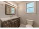 Modern bathroom with sleek vanity, decorative lighting, and framed mirror at 947 Rebel Forest Dr, Atlanta, GA 30315