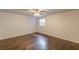 This bedroom features hardwood floors, a ceiling fan, and a sun-filled window at 947 Rebel Forest Dr, Atlanta, GA 30315