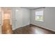 Bedroom with hardwood floors, light grey walls, and bright natural light at 947 Rebel Forest Dr, Atlanta, GA 30315