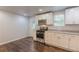 Updated kitchen features white cabinets, stainless steel appliances, and hardwood floors at 947 Rebel Forest Dr, Atlanta, GA 30315