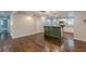 Open concept living and kitchen area showcasing hardwood floors, modern lighting, and an island bar separating the space at 947 Rebel Forest Dr, Atlanta, GA 30315