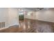 Open-concept living room showcasing hardwood floors, modern lighting, and seamless flow into the adjacent kitchen area at 947 Rebel Forest Dr, Atlanta, GA 30315