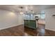 Open concept living and kitchen area showcasing hardwood floors, modern lighting, and an island bar separating the space at 947 Rebel Forest Dr, Atlanta, GA 30315