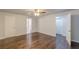 Spacious primary bedroom with hardwood floors, ceiling fan, and ensuite bathroom at 947 Rebel Forest Dr, Atlanta, GA 30315